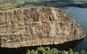 Cliff-face showing radial fracture pattern in Tensleep Fm. (sandstone), Alcova Reservoir, Wyoming.
